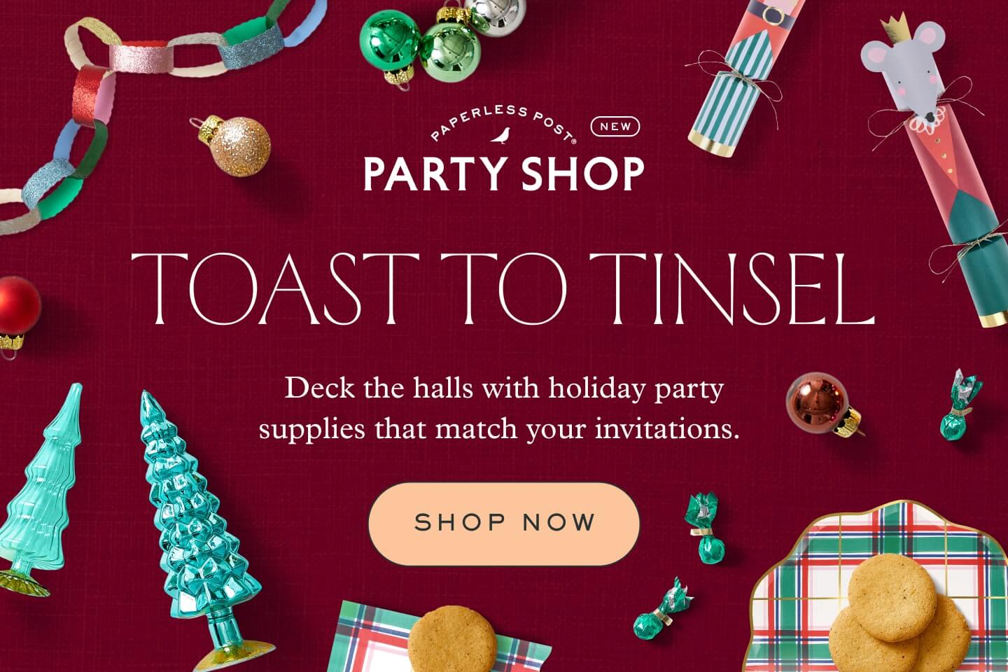 A dark red banner for Paperless Post Party Shop that reads "Toast to tinsel" with the message "Deck the halls with holiday party supplies that match your invitations" and the words "Shop now," surrounded by festive décor items like baubles, paper garland, and Christmas crackers.